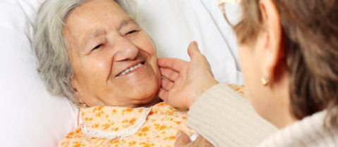 elderly smiling to her caregiver